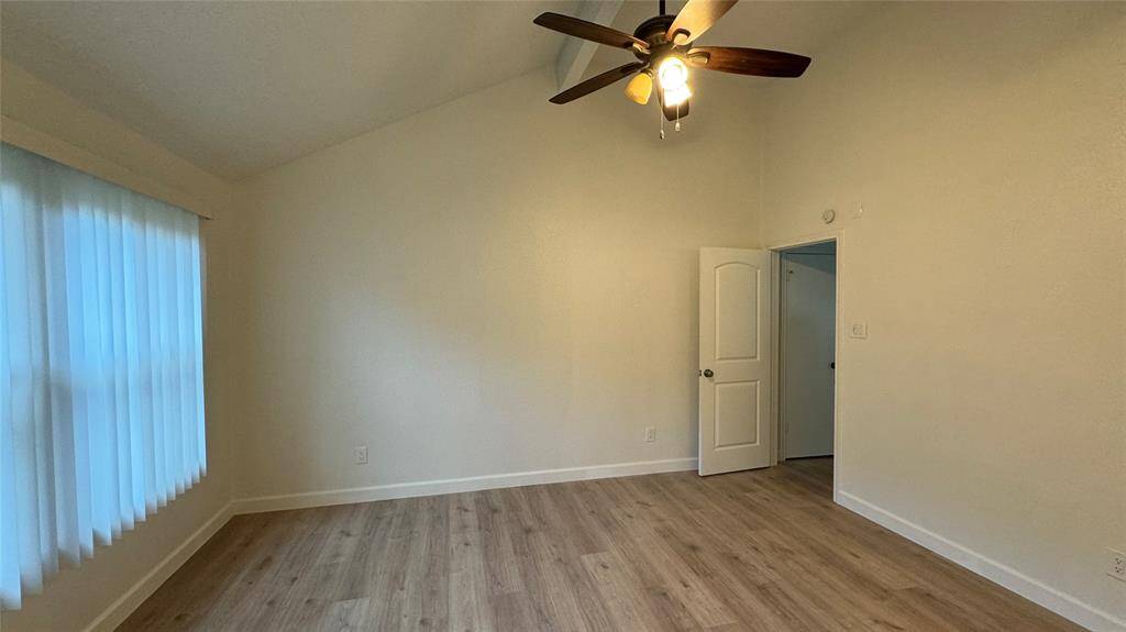 Primary bedroom with vaulted ceilings