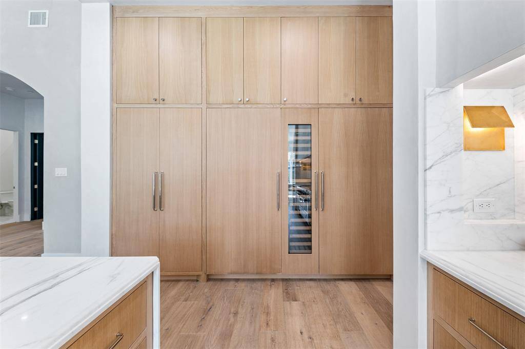 Custom white oak carpentry throughout this home soften this grand space making each expansive space feel unique in its own right.