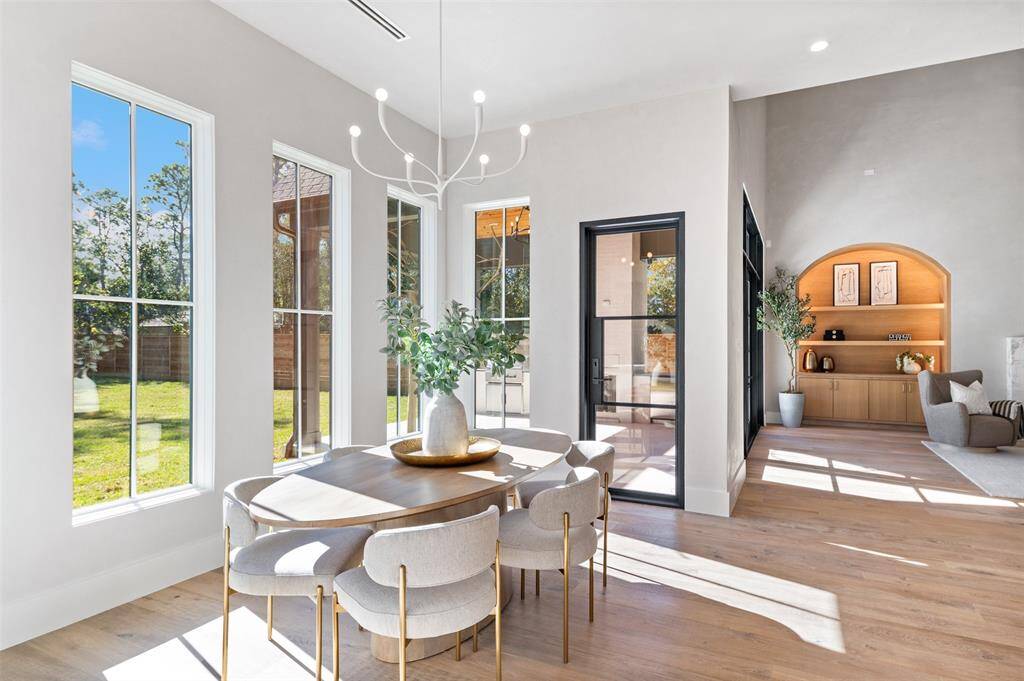 The breakfast nook opens gracefully to the living area, creating a sense of flow and connection throughout the home. The combination of sophisticated design, natural light, and open layout makes this the perfect spot for casual dining or enjoying a quiet morning.