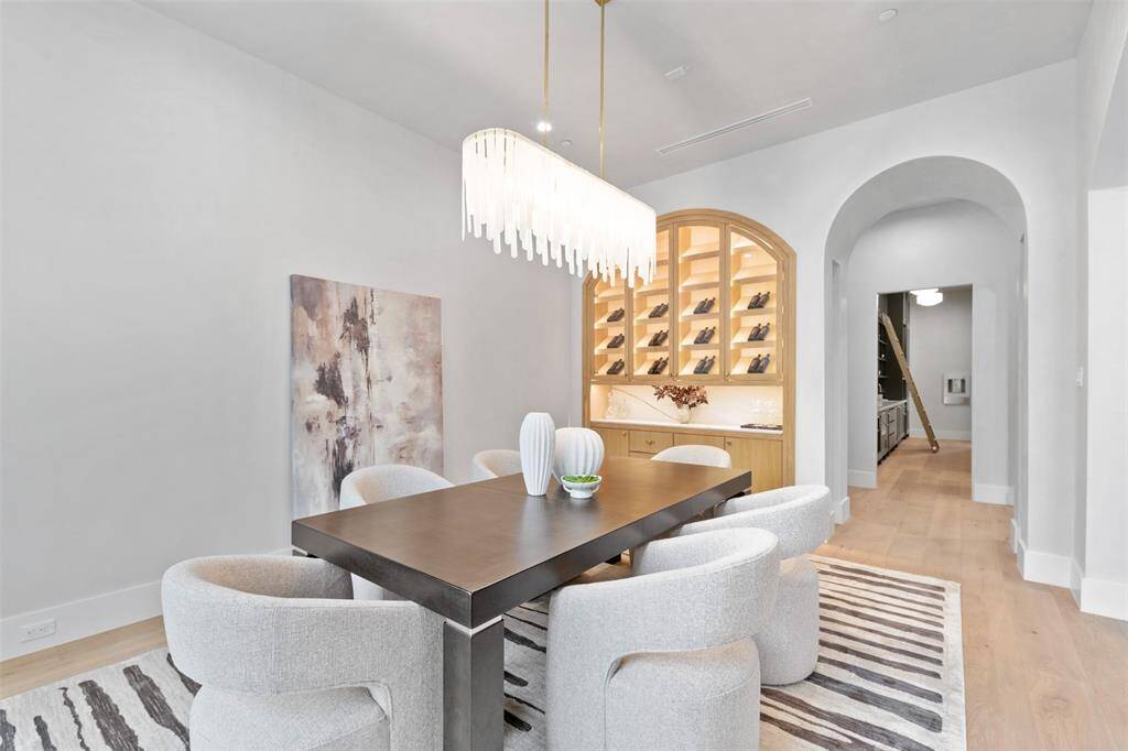 The space is bathed in soft, ambient lighting, highlighting the fine craftsmanship and luxurious materials throughout, making it the perfect setting for both intimate dinners and grand gatherings.