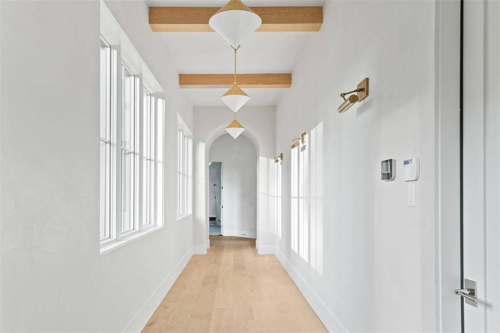 No space was left untouched. The walkway to the downstairs suite features stunning hand scrapped hardwoods, designer light fixtures and is already preped to feature you favorite art or photos.