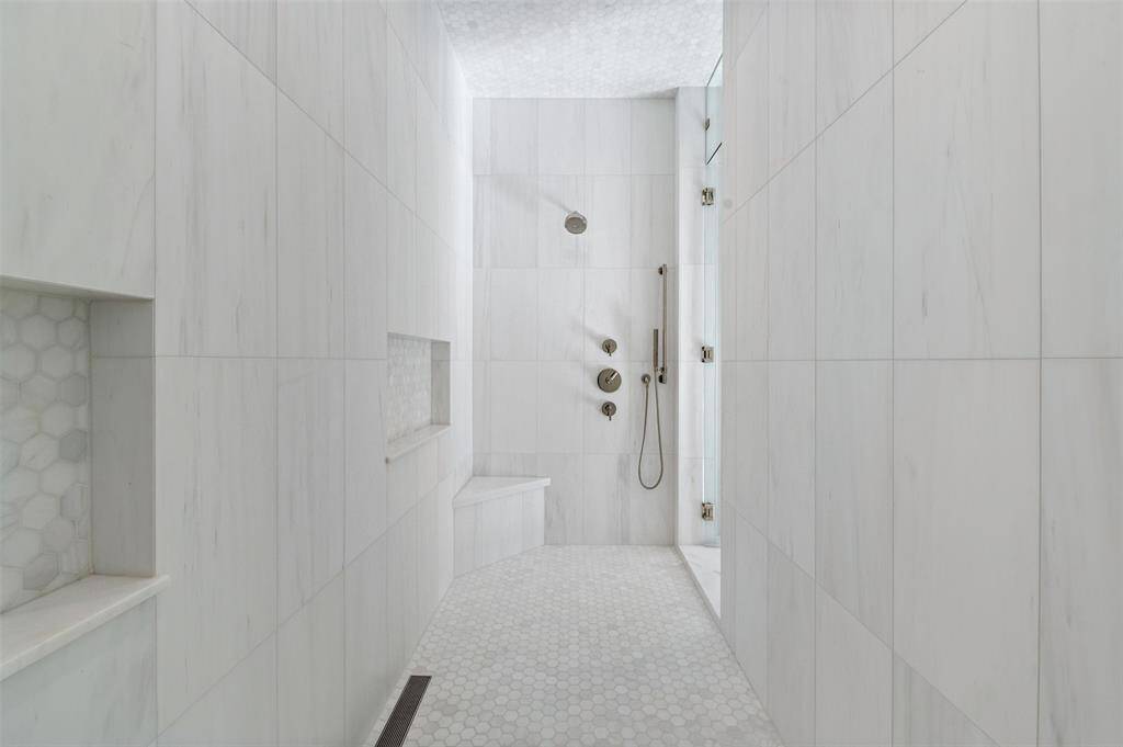 The expansive shower features dual shower heads, offering an unparalleled level of comfort and convenience.