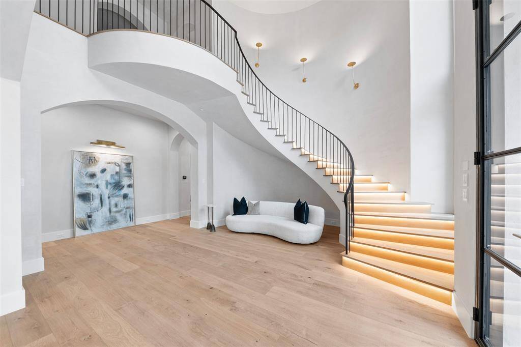 The floating staircase stands as a breathtaking masterpiece, seamlessly blending artistry with architectural brilliance. Each step adorned with LED lighting that emits a warm inviting glow.
