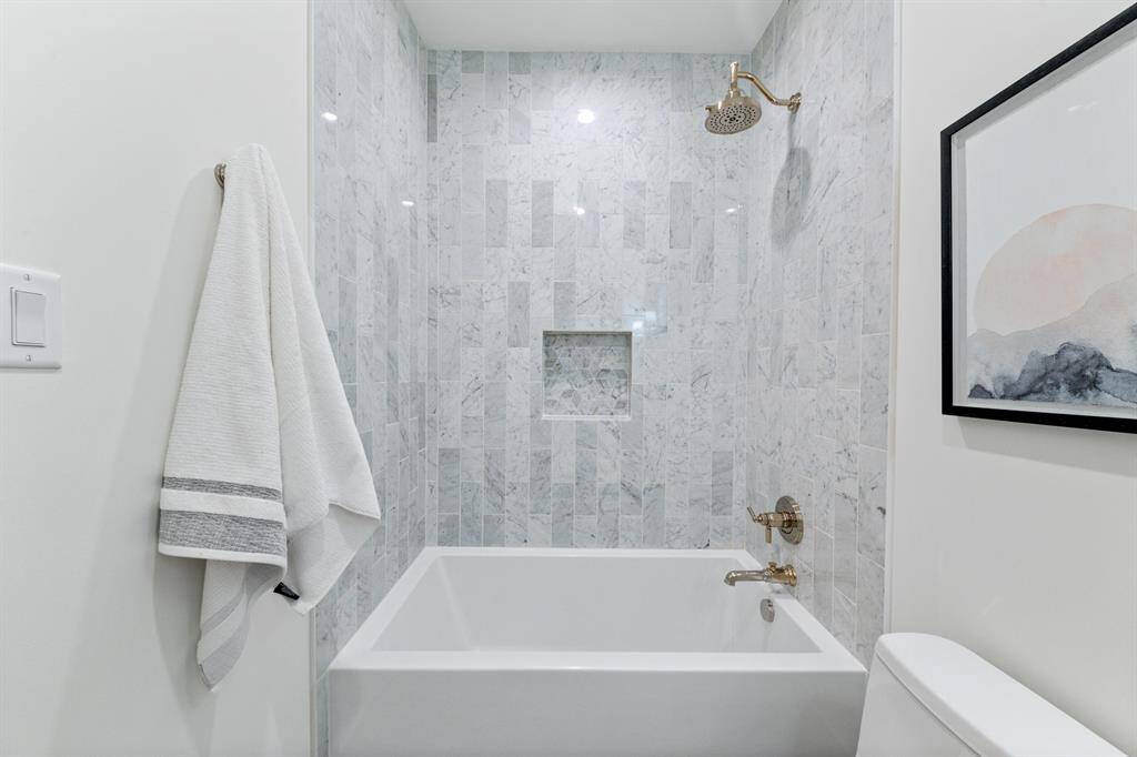 This elegant secondary bathroom exudes sophistication with its sleek designer finishes and premium tilework. Designer fixtures and soft, ambient lighting create a spa-like atmosphere, while the beautifully tiled shower adds a touch of modern luxury. Every detail has been thoughtfully designed to enhance both comfort and aesthetics.