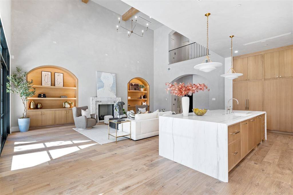This luxurious kitchen is a masterclass in both style and functionality. Custom paneled appliances seamlessly blend into the cabinetry, creating a clean, sophisticated aesthetic.