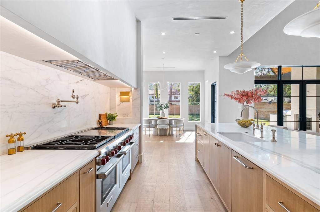 A convenient pot filler is mounted above the stove, adding both practicality and a touch of elegance.