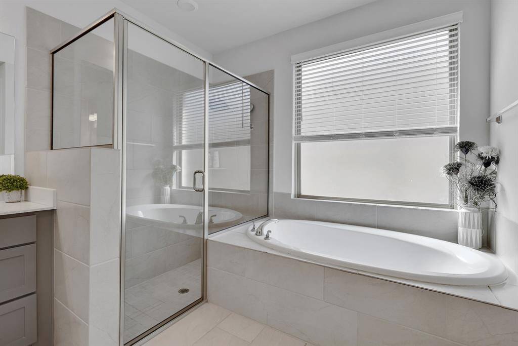 Primary bath with walk in shower and garden tub.
