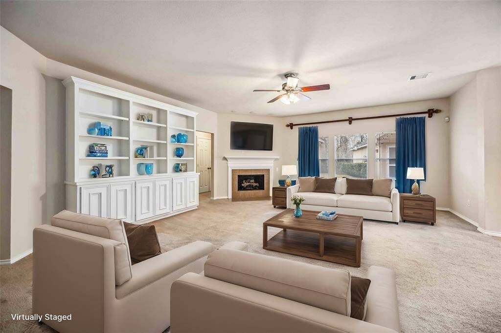 Living room with fireplace and custom build cabinet.