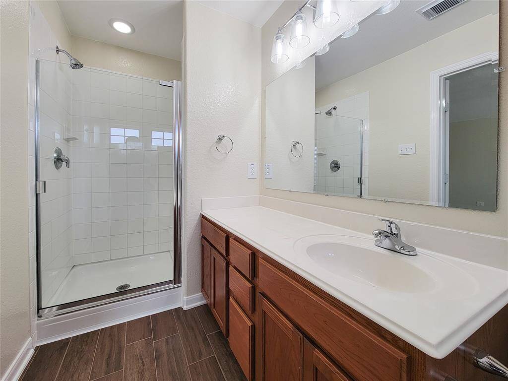 Separate shower and soaking bathtub in the primary bathroom