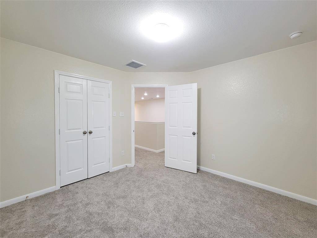 The secondary bedroom is large enough to accommodate Queen furniture, and has a walk-in closet