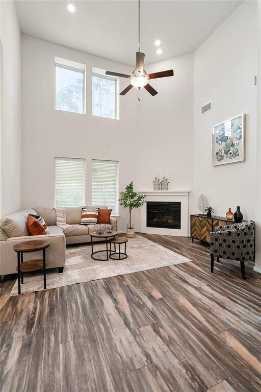 Living room featuring two story ceiling and beautiful windows