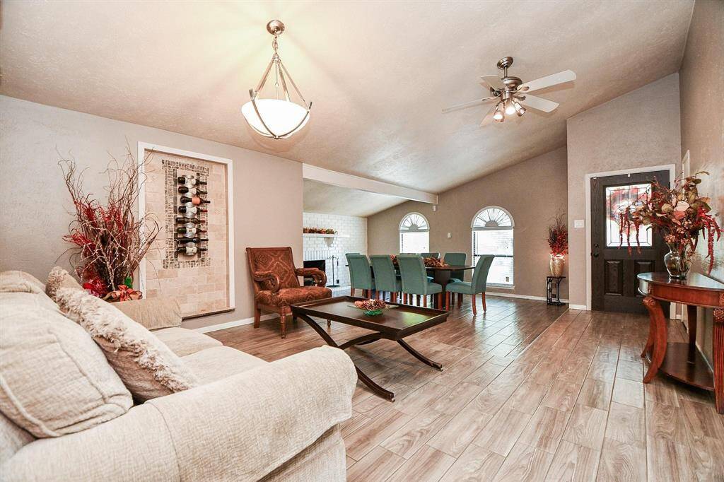 One-step separates Living/Dining Rooms and Sunroom shown