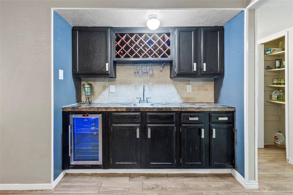 Shown: Wetbar featuring Wine Chiller and Wine Rack with Stone Backsplash