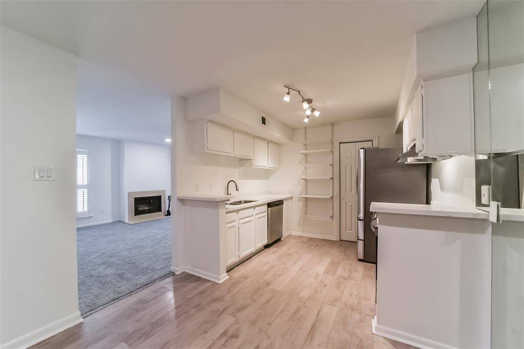 Bright and modern kitchen featuring brand-new, high-end appliances.
