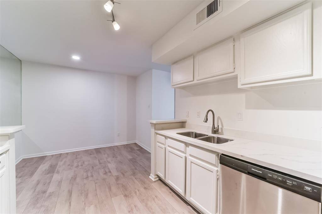 Spacious breakfast area in a freshly updated kitchen with sleek quartz countertops, a brand-new faucet, and a new dishwasher.