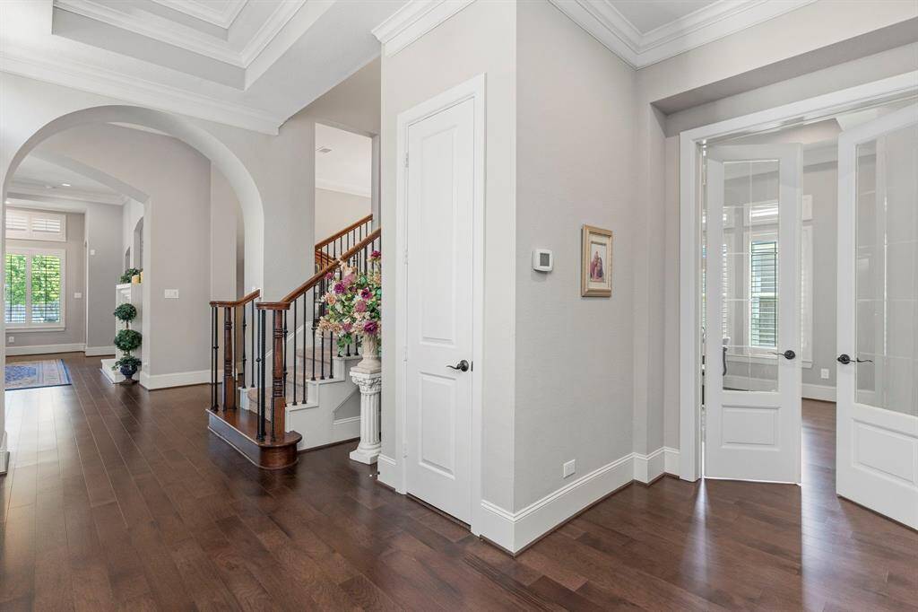 Wow! Stunning tall custom French glass doors open to reveal your outstanding home office or study—a perfect blend of style and functionality