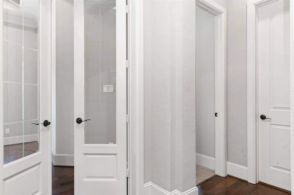 Nestled down a private hallway, you'll find the spacious downstairs guest suite, offering comfort and seclusion.All the tall custom doors make this home amazing!