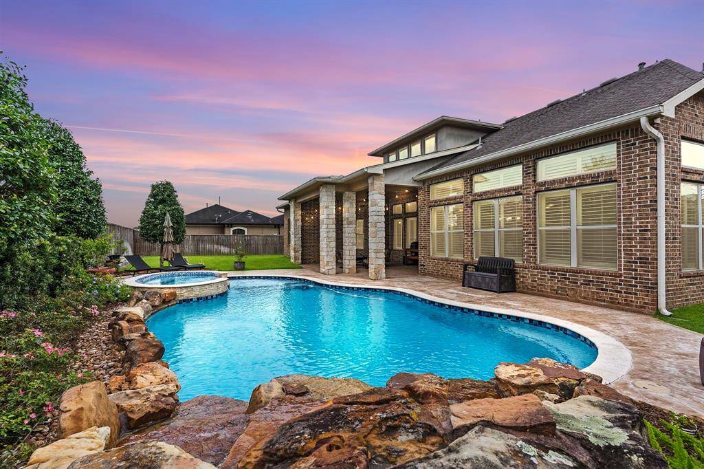 This stunning David Weekley home sits on an expansive 13,671-square-foot private lot with no rear neighbors! The backyard is a true oasis, featuring a spacious covered patio, a heated saltwater pool, and more. Located in the exclusive gated community of Sterling Creek, it offers top-rated schools for all ages, no MUD taxes, a low tax rate, and convenient access to the best of the Bay Area.