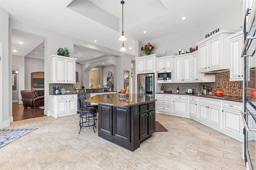 The kitchen is a chef's dream, offering incredible space, top-of-the-line granite countertops, stainless steel double ovens, and more—everything you need to create culinary masterpieces!