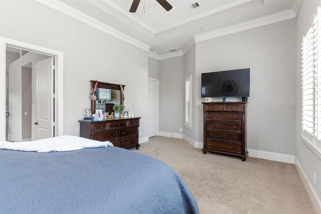 Escape to this fabulous owner's suite, designed with both of you in mind! Enjoy separate vanities for 'her' and 'his,' each offering ample storage space. The bathroom features beautiful cabinetry, stunning granite countertops with deep undermount sinks, framed mirrors, and soaring high ceilings. The Texas-sized shower, with a seamless glass door, adds a touch of luxury, and the list of upgrades goes on and on!