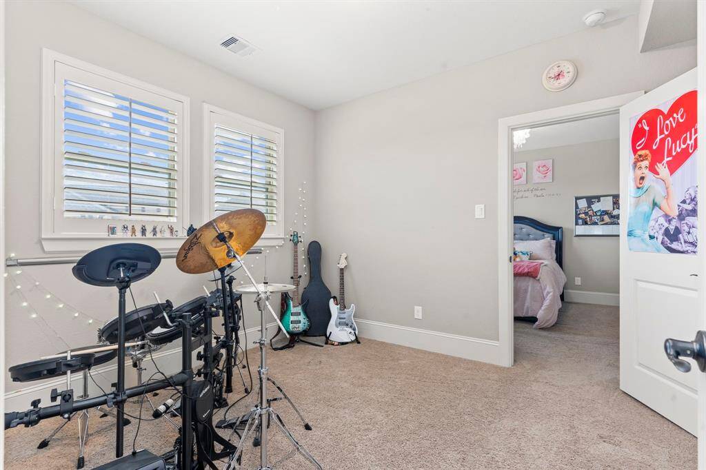 Upstairs, you’ll find a flexible room—perfect as a private playroom for the two guest bedrooms to share! What a fabulous floor plan, designed for both function and fun!