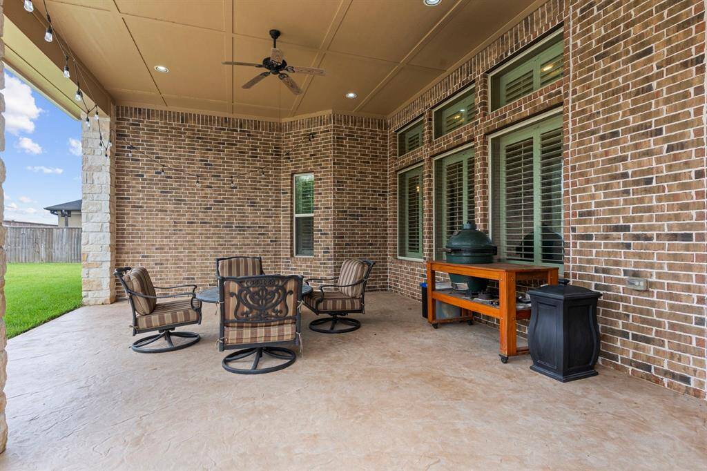"Delight in your expansive covered patio, perfect for all your outdoor entertainment needs!