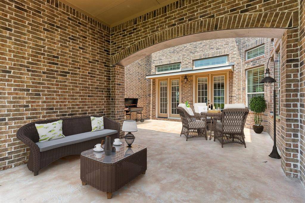 Charming covered front courtyard, perfect for relaxing or entertaining! Virtual Staging