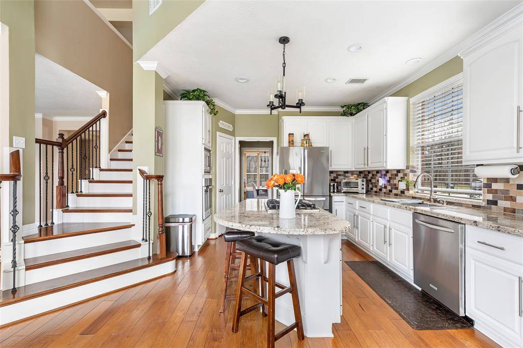 Upgraded stairs come up from the kitchen! Love these floors!