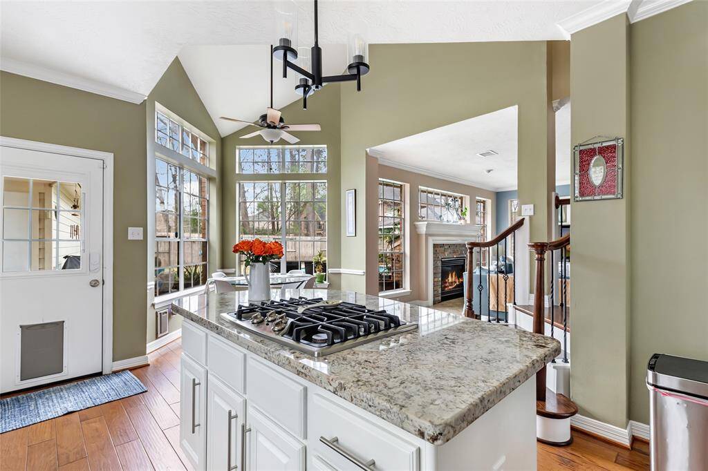 Island with gas cooktop provides additional storage as well as prep space. View directly into the family room and breakfast area.