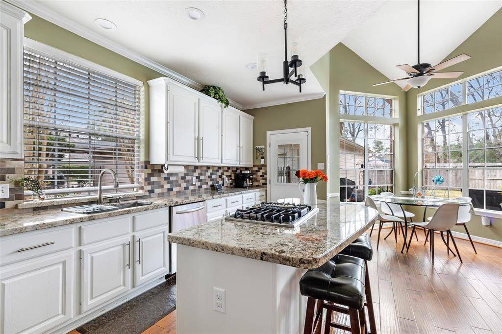 Galley style kitchen is nicely updated! Door leads out to covered walk way to the detached garage.