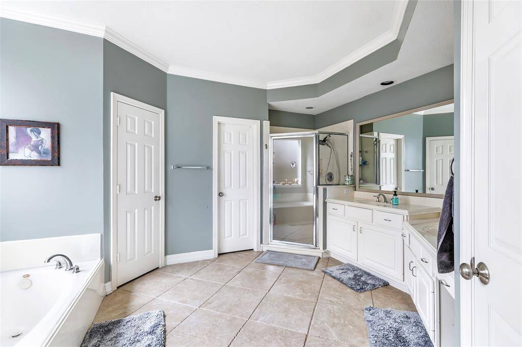 Spacious bath for the new owner has it all! Double sinks - no sharing here - vanity - for her! Jacuzzi tub and separate shower!