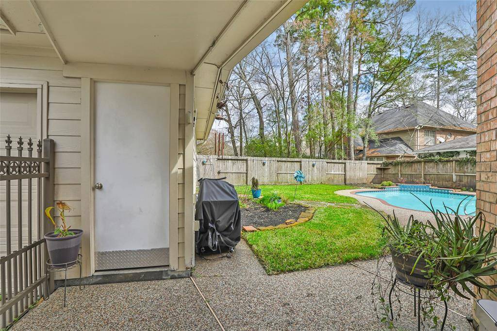 Covered area between house and detached garage. Iron gate for access.
