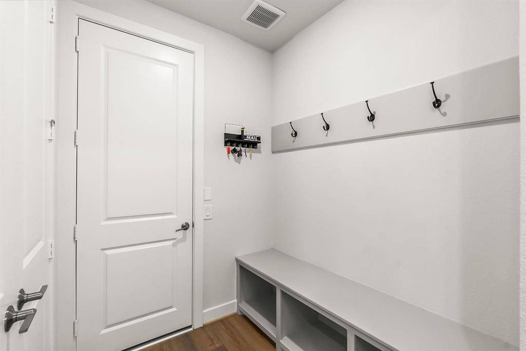 Large storage valet built in mudroom coming in from the garage