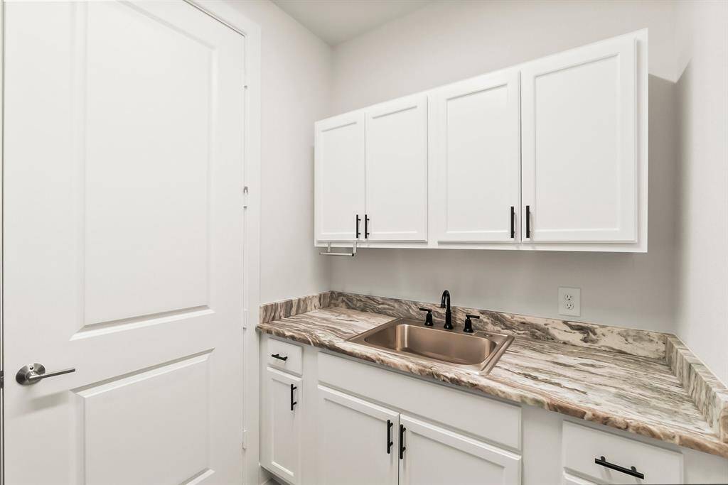 Cabinetry and sink in the laundry room
