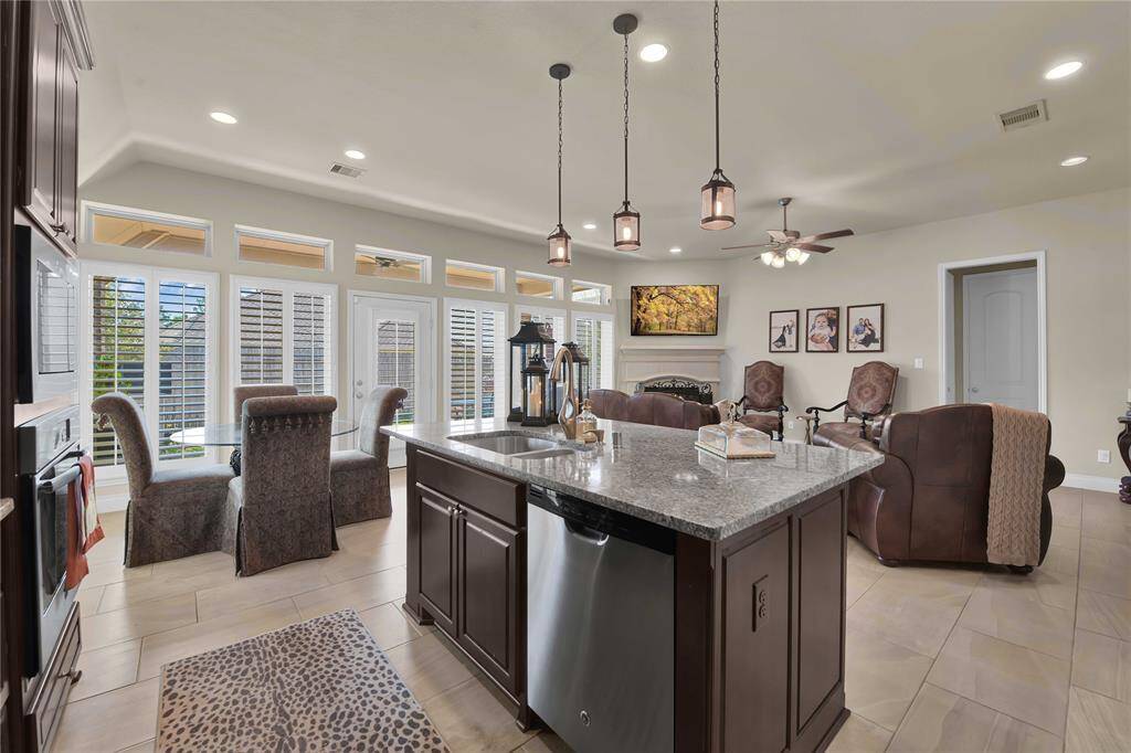 The undermount sink offers both functionality and a sleek aesthetic, while the dishwasher, built-in oven, built-in microwave, and gas cooktop provide all the tools needed for culinary mastery.