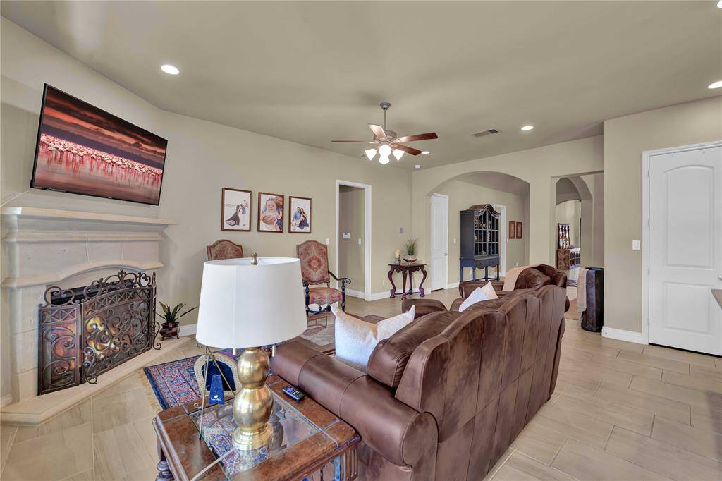 In one corner, a cozy gas-log fireplace serves as a focal point, offering a perfect spot to gather on cooler evenings. Whether you’re hosting friends, enjoying family movie nights, or simply unwinding after a long day, this family room is an ideal backdrop for all of life’s moments.