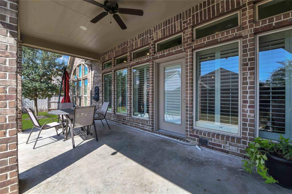 Out back, an oversized covered patio provides plenty of space for outdoor enjoyment while keeping you shaded from the Texas sun. This inviting area is perfect for al fresco dining, relaxing with a book, or hosting gatherings with family and friends. The generous size allows for versatile furniture arrangements.