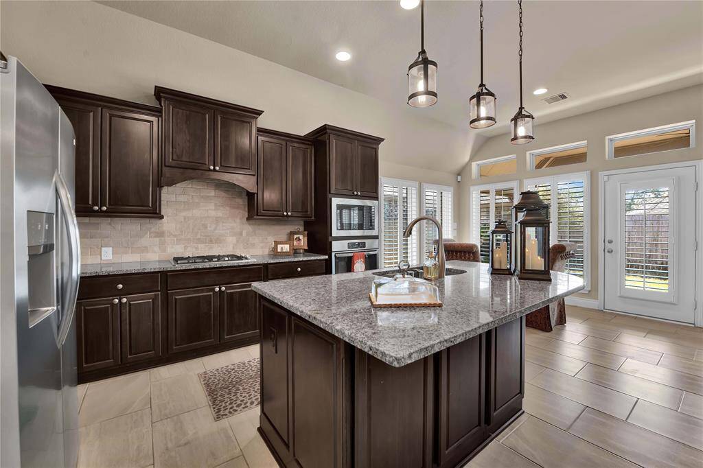 Open to the family room is the stunning chef's island kitchen, thoughtfully designed to inspire culinary creativity and make every cooking experience enjoyable. At the center of this space, an expansive island showcases a large breakfast bar, ideal for casual dining and entertaining.