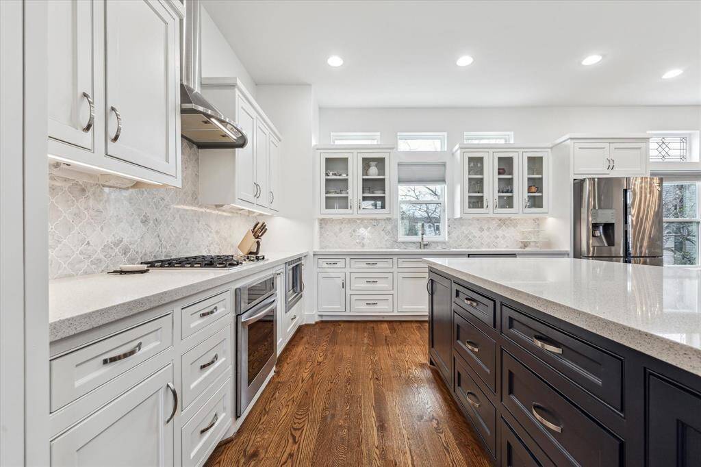 Another view of the corner kitchen with wrap-around cabinets. Plenty of storage in pull-out drawers for pots and pans. All cabinets and drawers are soft-closed. Under cabinet lighting illuminates the kitchen.