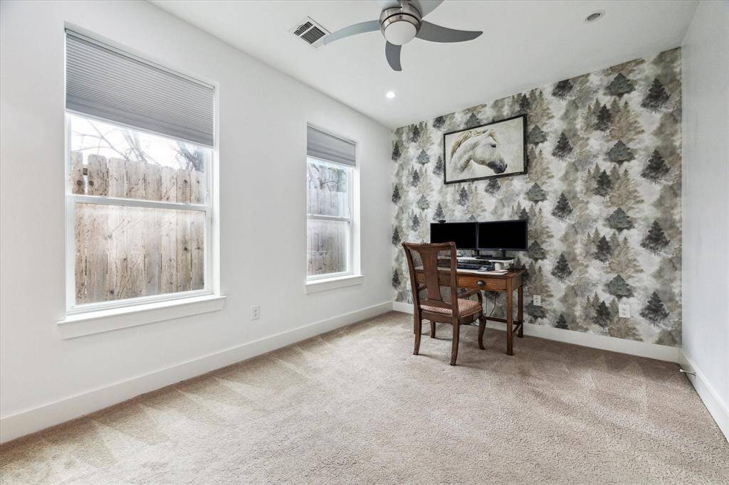 The first-floor bedroom currently being used as an office features a walk-in closet and en-suite bathroom with shower.
