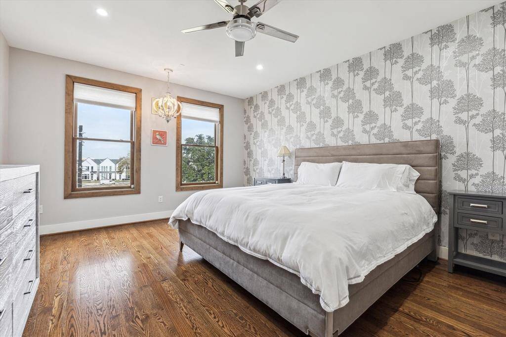 The primary retreat is located on the 3rd floor of the home and features a wallpaper main wall, custom lighting, and huge walk-in primary closet.