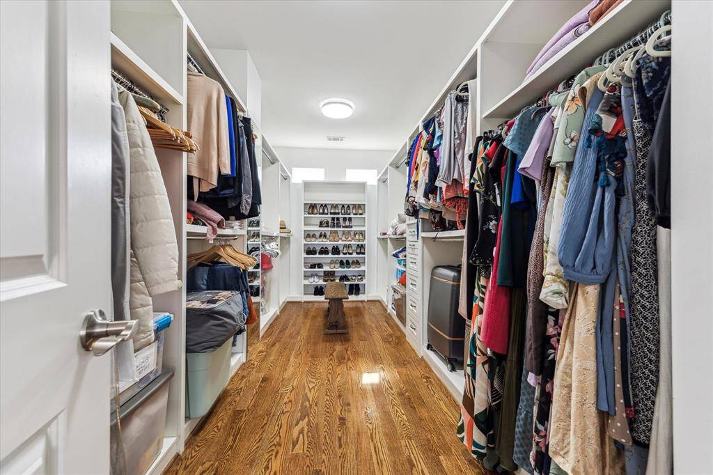 Step into the master closet of your dreams, where organization meets luxury! Designed for maximum storage and convenience, this expansive walk-in closet boasts tons of hanging space, perfect for keeping your wardrobe neatly arranged. Custom-built drawers and shelving provide ample room for accessories, shoes, and seasonal items, ensuring everything has its place. Whether you're a fashion enthusiast or simply love a well-organized space, this closet offers functionality.