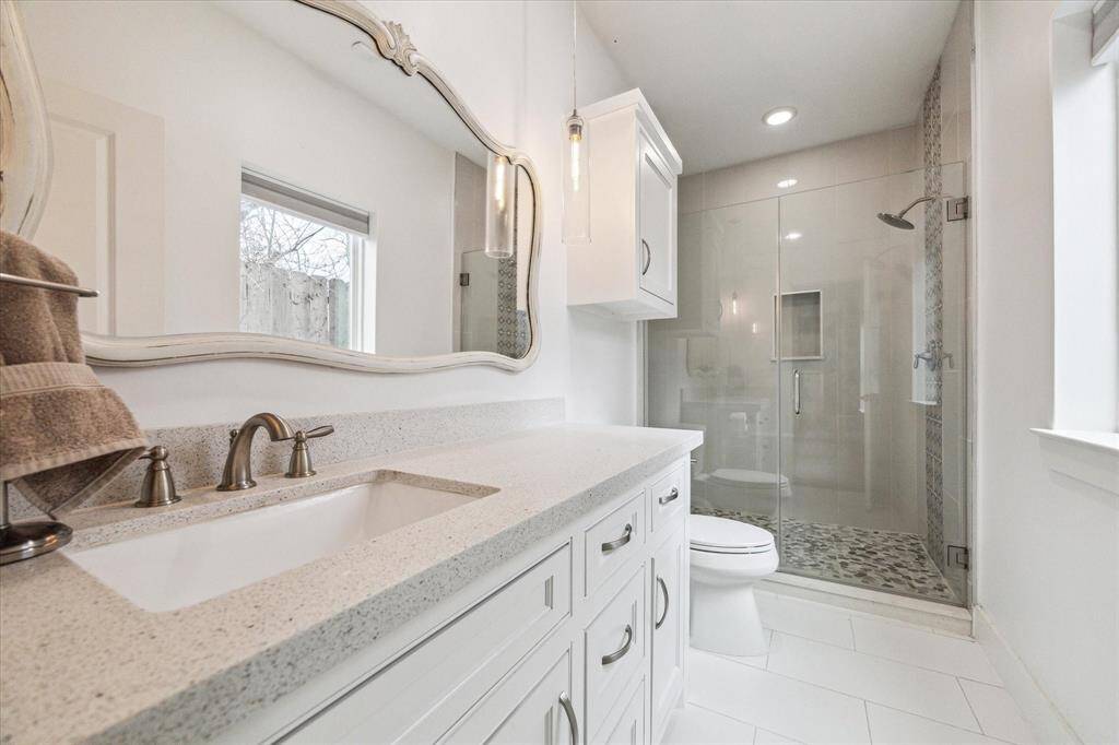 Experience the perfect blend of luxury and privacy in this first-floor en-suite bath. Designed for both comfort and sophistication, this space features gleaming quartz countertops that add a touch of elegance, while the spacious walk-in shower offers a spa-like retreat. Thoughtfully positioned for ultimate privacy, this bathroom is an ideal sanctuary for guests or multigenerational living or guest room.