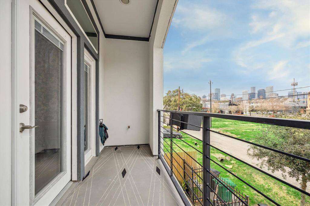 Step onto the expansive second-floor balcony, where breathtaking downtown Houston views create the perfect backdrop for morning coffee or evening relaxation. Designed for both comfort and style, this outdoor retreat seamlessly extends the living space, offering a serene escape with fresh air and cityscape sights. Whether you're enjoying a quiet moment alone or entertaining guests, this balcony is a true urban oasis.
