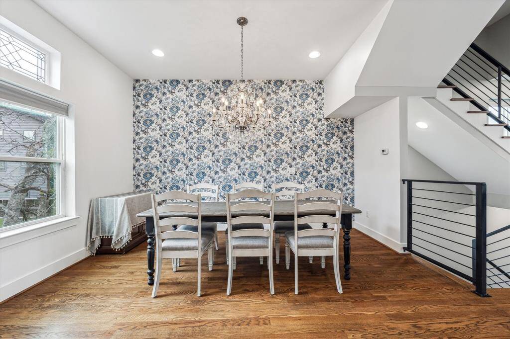 This designated dining space is cozy and open to the kitchen and living room. Accent wall with wallpaper and lovely lighting compliments the space.
