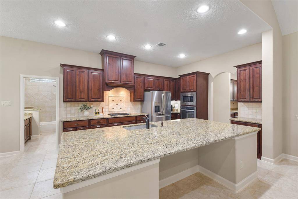 This large kitchen island is the heart of this space.