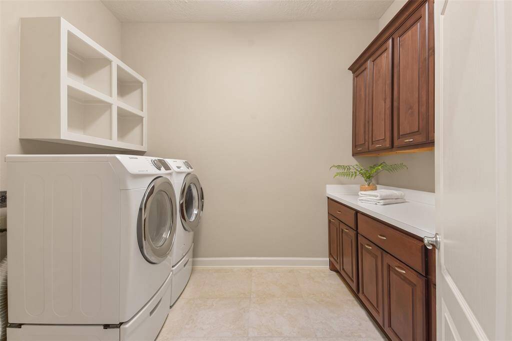 Large laundry room with plentry of storage and room for extra refrigerator or freezer if needed