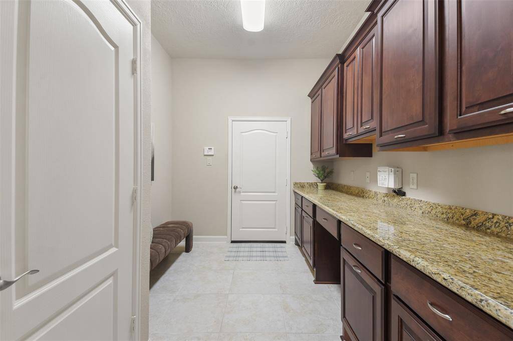 Entry from garage. Workspace and extra storage closet as well