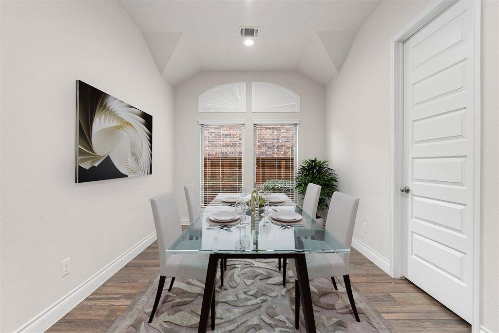 Large breakfast area in the kitchen. The door goes to the laundry room. Virtually staged.