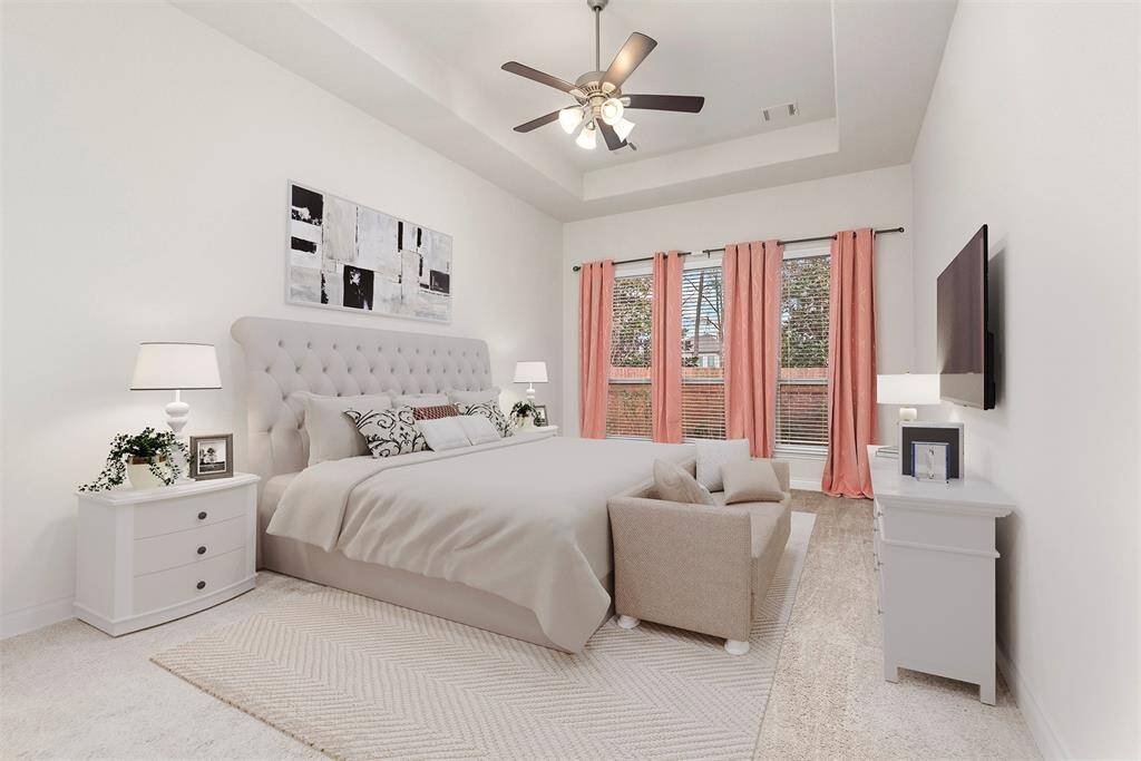 Primary bedroom with tall tray ceilings